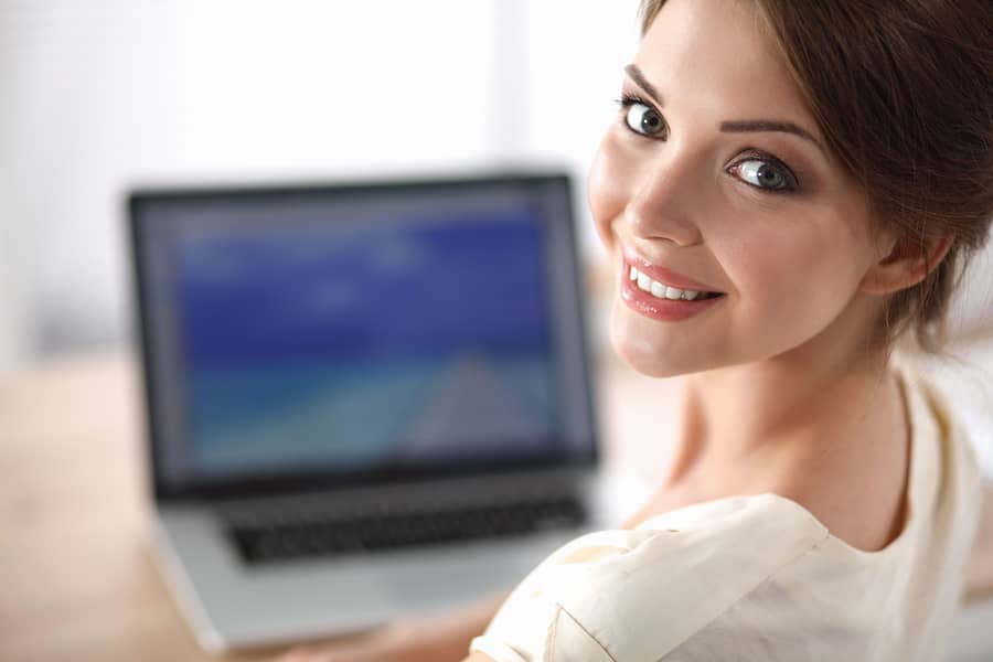 woman at laptop smiling