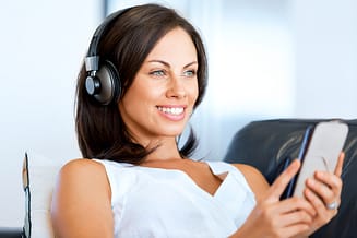 woman with headphones on mobile phone